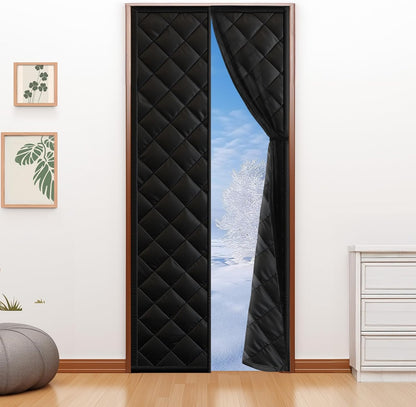 Fillis black quilted thermal insulated door curtain hung on a standard interior doorway, open to a snowy view